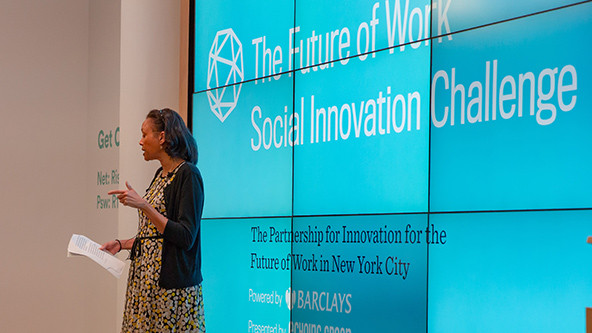 Cheryl Dorsey, an African-American woman, stands on stage at the 2018 Barclays Social Innovation Challenge in New York City.
