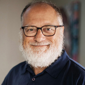 headshot of adam kahane