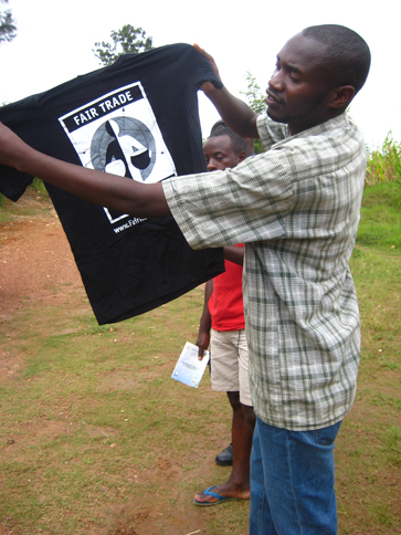 A member of the Abakunda Kawa cooperative in Rwanda proudly displays a Fair Trade Certified T-shirt.