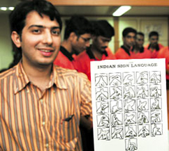 Social entrepreneur and Mirakle Couriers founder Dhruv Lakra holds up a sign language chart. (Photos courtesy of Devanik Saha)