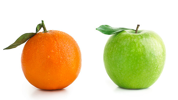 An orange next to a green apple