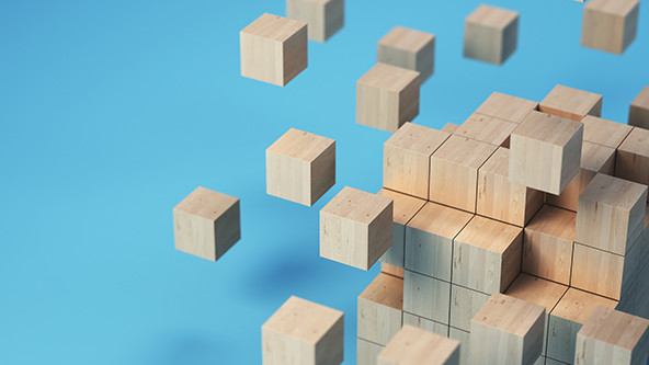 Cube formation made of wooden blocks on soft blue background