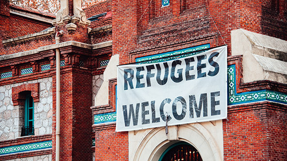 'Refugees Welcome' banner hanging from building