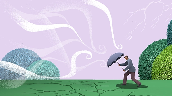 Man holding an umbrella up against gusts of wind