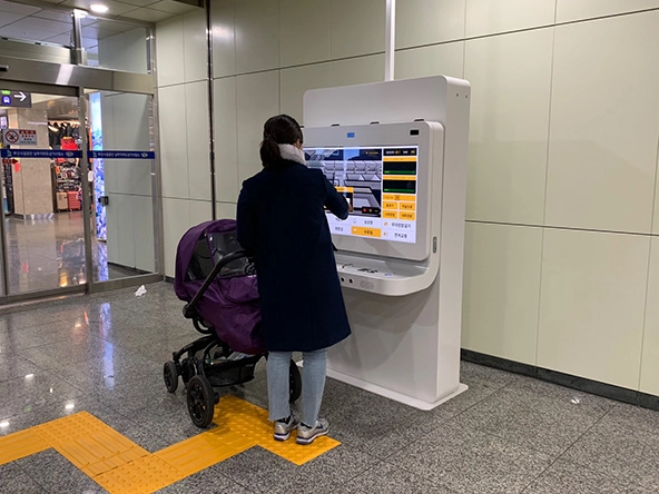 Woman standing at a kiosk