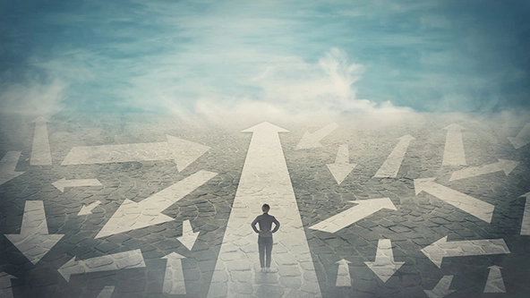 Doubtful person, hands on hips, choosing the way as multiple arrows on the road showing a mess of different directions.