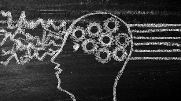chalkboard drawing of human head with gears thinking through a problem