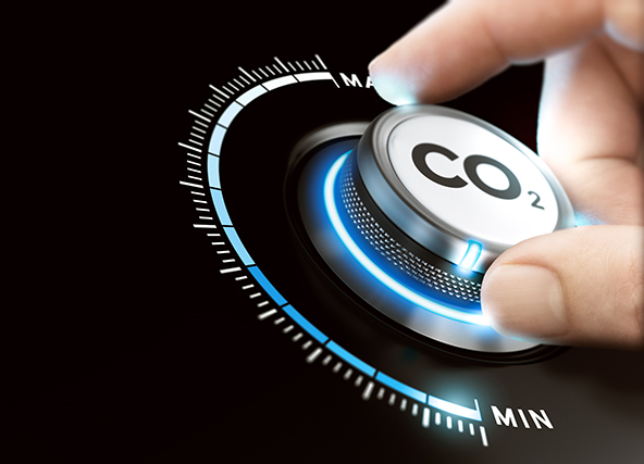 Man turning a carbon dioxide knob to reduce emissions.