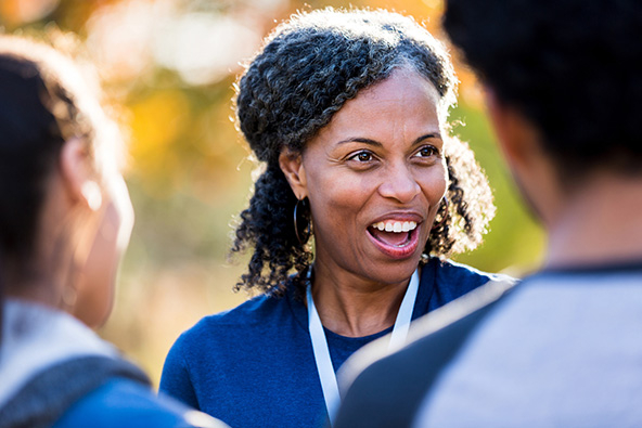 Older African-American woman talking with two young people