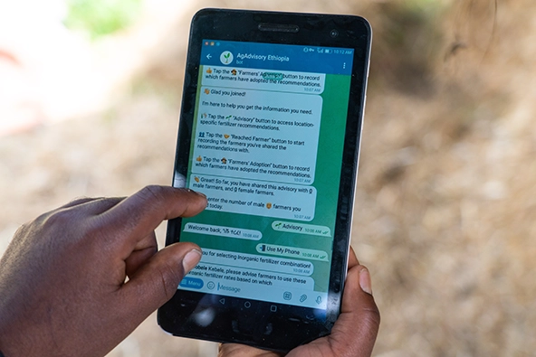 Hands holding a tablet using ai-powered assistant