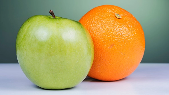 Photo of a green apple and an orange
