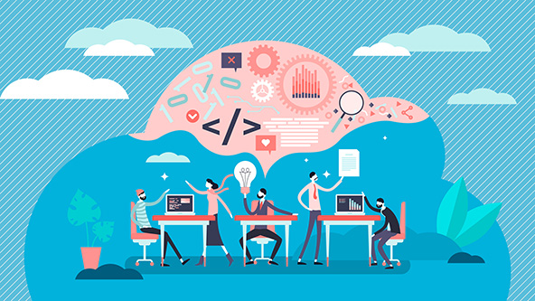 People sitting at tables with computers, one person holding a lightbulb