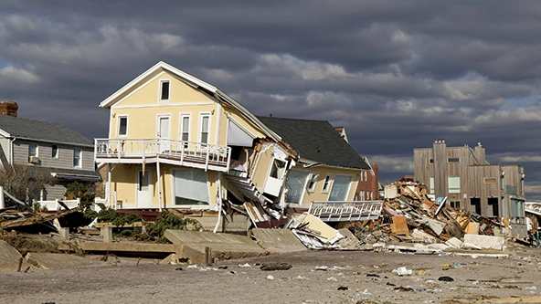 A two-story home that has partially collapsed.