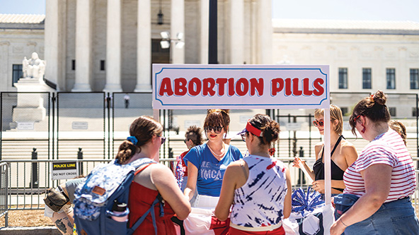 Volunteers handing out refreshments and information about abortion pills in front of the US Supreme Court building