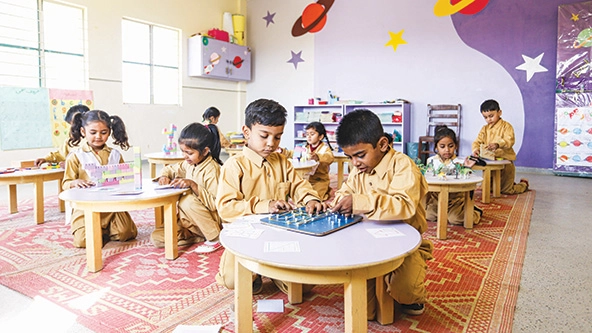 Young students in a classroom at small tables