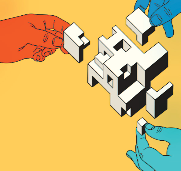 Hands putting together geometric shapes to form a cube