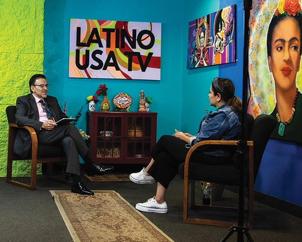 a discussion on Latinx heritage between two people in front of cameras for a TV show