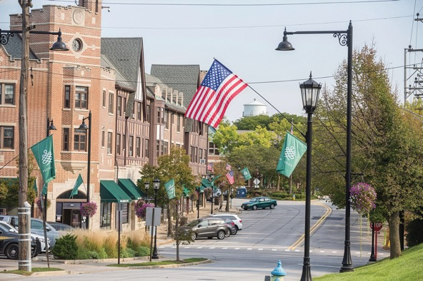 a suburb street with an American flag flying over it