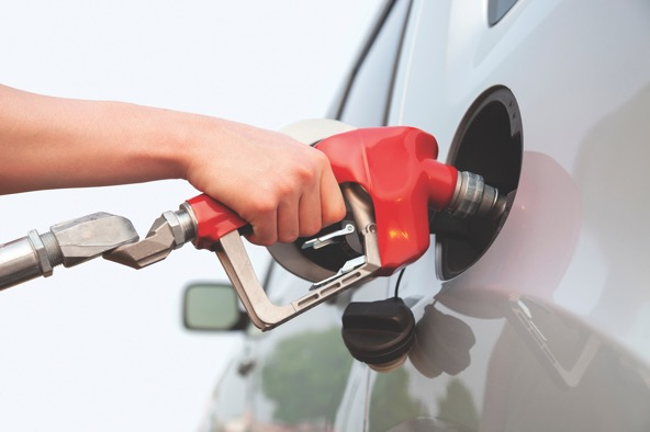 hand pumping gas into car