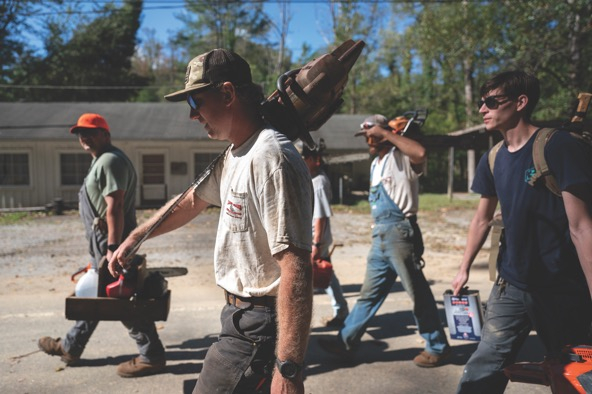workers carrying tools and walking