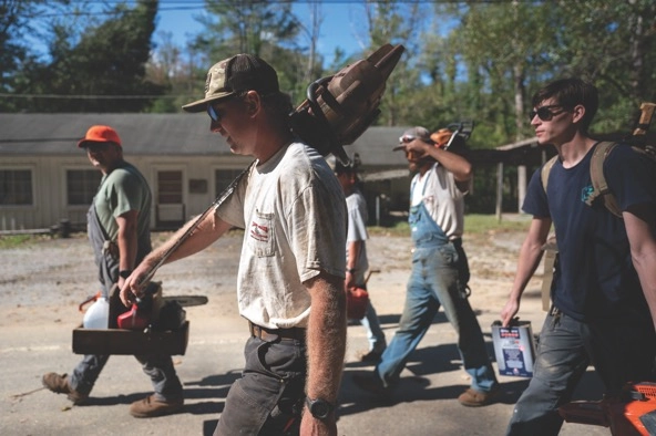 workers carrying tools and walking