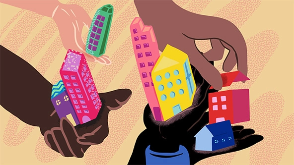 Hands holding houses and apartments buildings