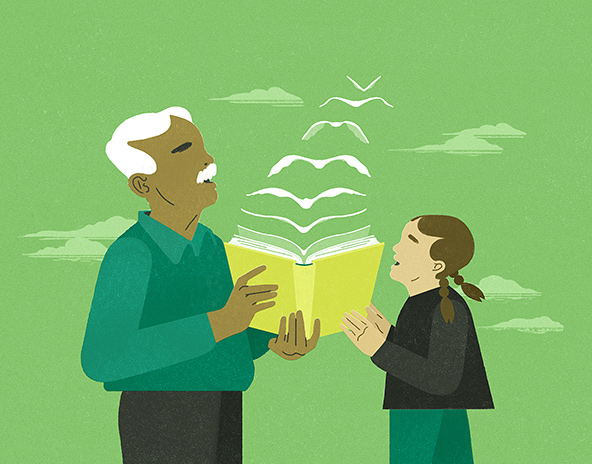 Older man and young girl holding a book and reading together