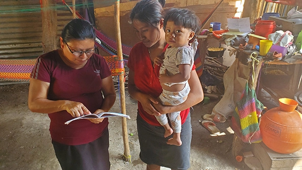 woman standing with a mother and child
