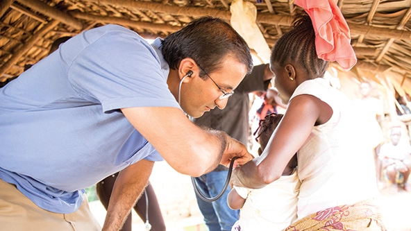 doctor checking a baby's heartbeat with stethoscope