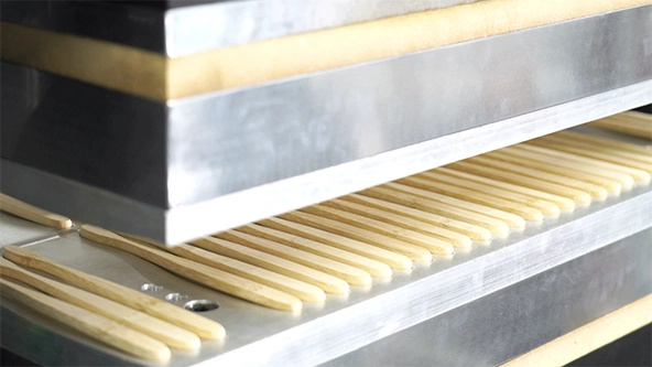 A mechanical press forming toothbrushes