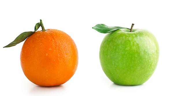 An orange next to a green apple