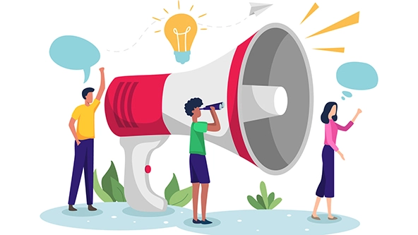 Men and women promoting standing next to large megaphone