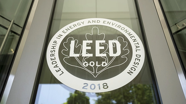 The LEED certification logo printed on the glass exterior of a building