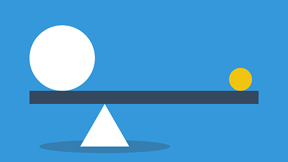 One bid and one small ball in equilibrium on a seesaw showing balance