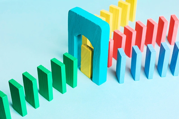 three rows of dominoes coming together toward one row