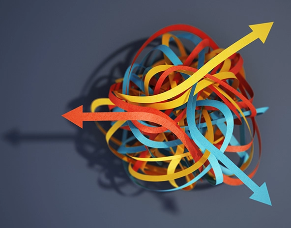 Tangled paper strips blue, yellow and red with arrows pointing different ways