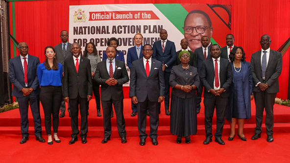 Photo of men and women standing on stairs, facing camera