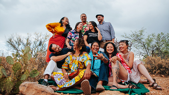 Group of people together outside posing for a photo