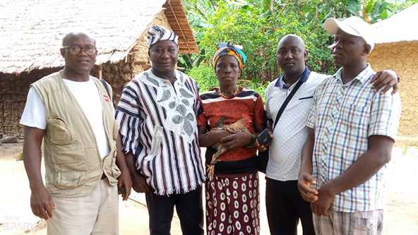 Five people who defended their land rights in Sierra Leone standing together, facing the camera.
