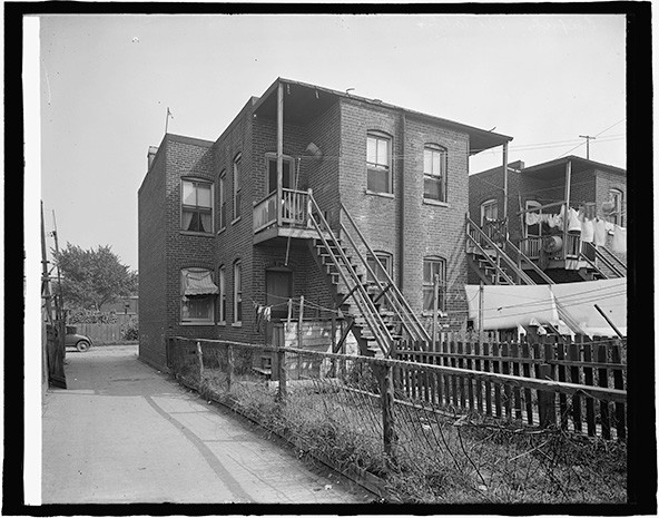 Black and white photo of a two-story brick home from 1916