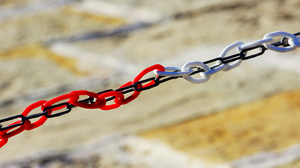 A red and white chain wrapped around a black chain