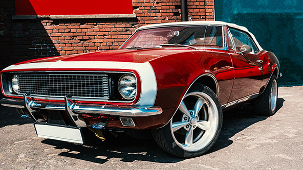 hot red muscle car on brick wall background