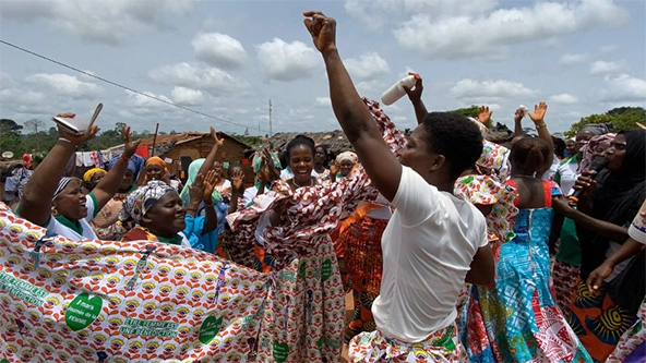 Crowd of women with arms raised in celebration
