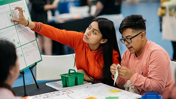 Young people sitting at a table.