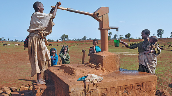 Woman using a water pump