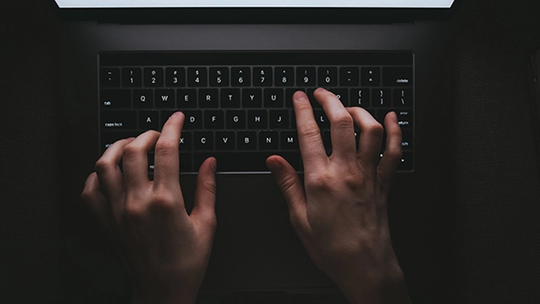 Overhead view of woman typing on a laptop