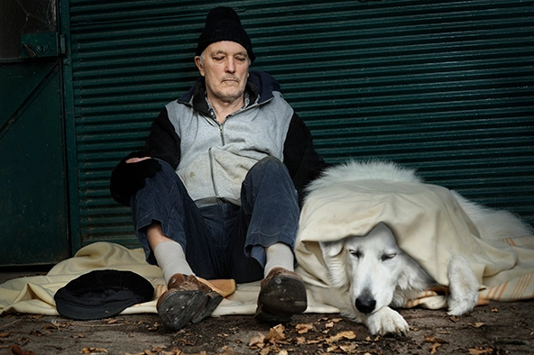 Homeless man with his dog on the street