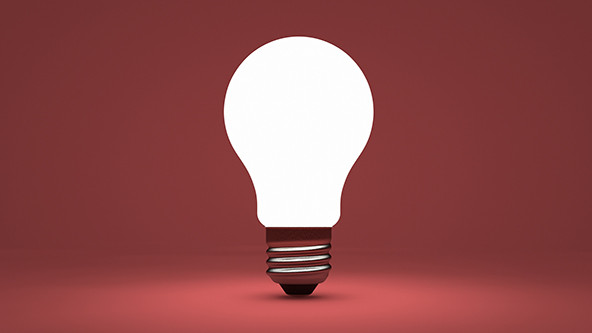 Shining lightbulb on a maroon background