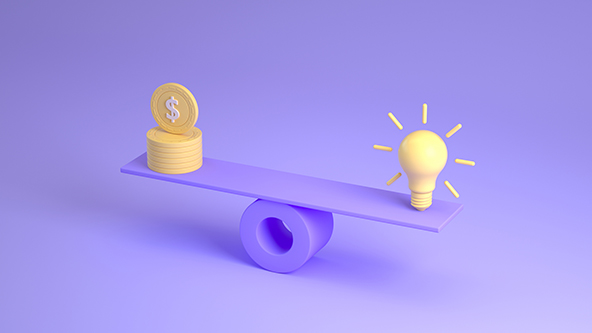 light bulb and a stack of coins on a scale.
