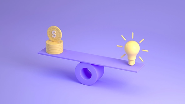 light bulb and a stack of coins on a scale.